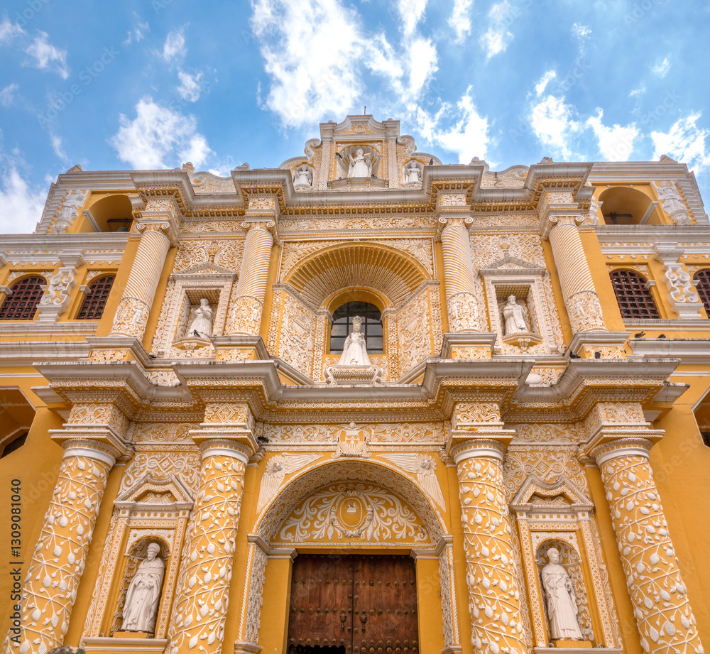 Fototapeta premium The magnificent yellow and white facade of the church of La Merced (Iglesia de la Merced), Antigua, Guatemala