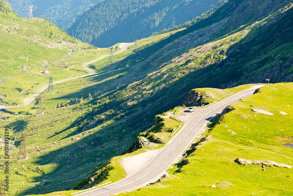 transfagarasan road winding uphill. beautiful scenery. travel destination in romania mountain landscape. sunny day in summer. view in to the valley. dangerous route