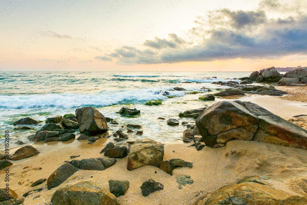 summer vacation landscape at the beach. dramatic seascape at sunrise. calm wave washing the coast with sand and rocks. beautiful view of sky with sun and cloud above horizon