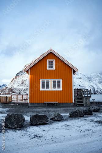 A Vibrant and Bright Orange House Nestled in a Beautiful Winter Landscape Setting