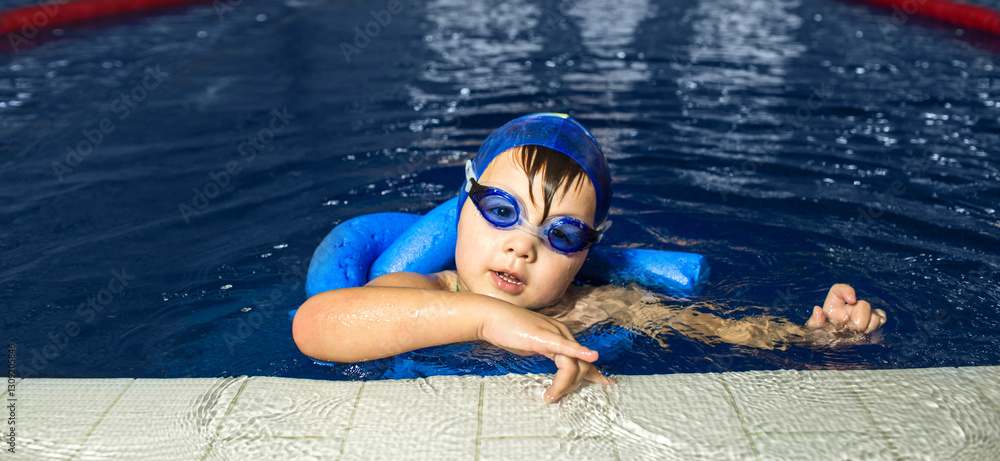 © Peakstock - Child is engaged in swimming training, practicing strokes and gaining confidence in the water during a structured lesson