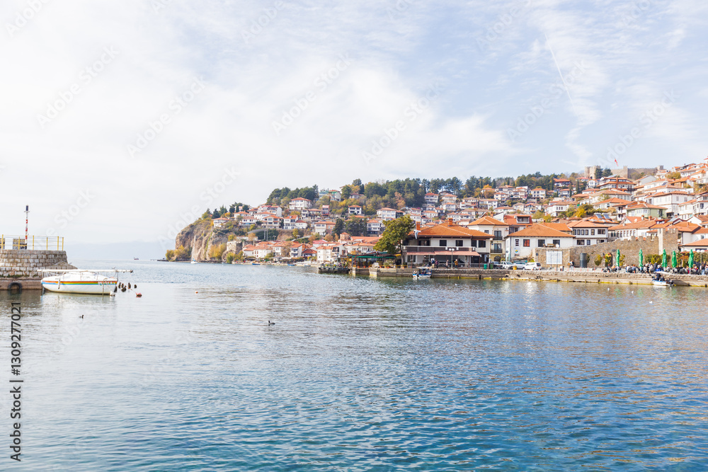 Picturesque coastal town Ohrid on a hillside by calm Lake Ohrid, clear sky, creating a serene and historical view. Picturesque coastal town Ohrid on a hillside by calm Lake Ohrid, clear sky, creating a serene and historical view.