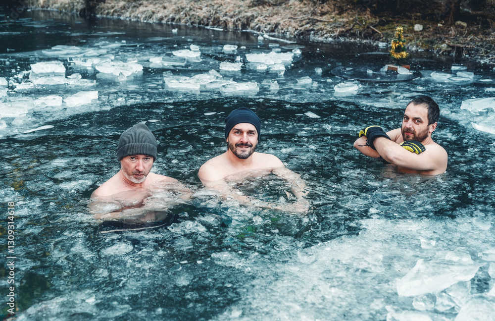 Fototapeta premium Three men hardening in a frozen pond. winter hardening.