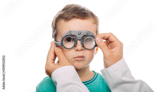 Fotografie Young boy is being fitted with trial frame glasses while receiving an eye exam b