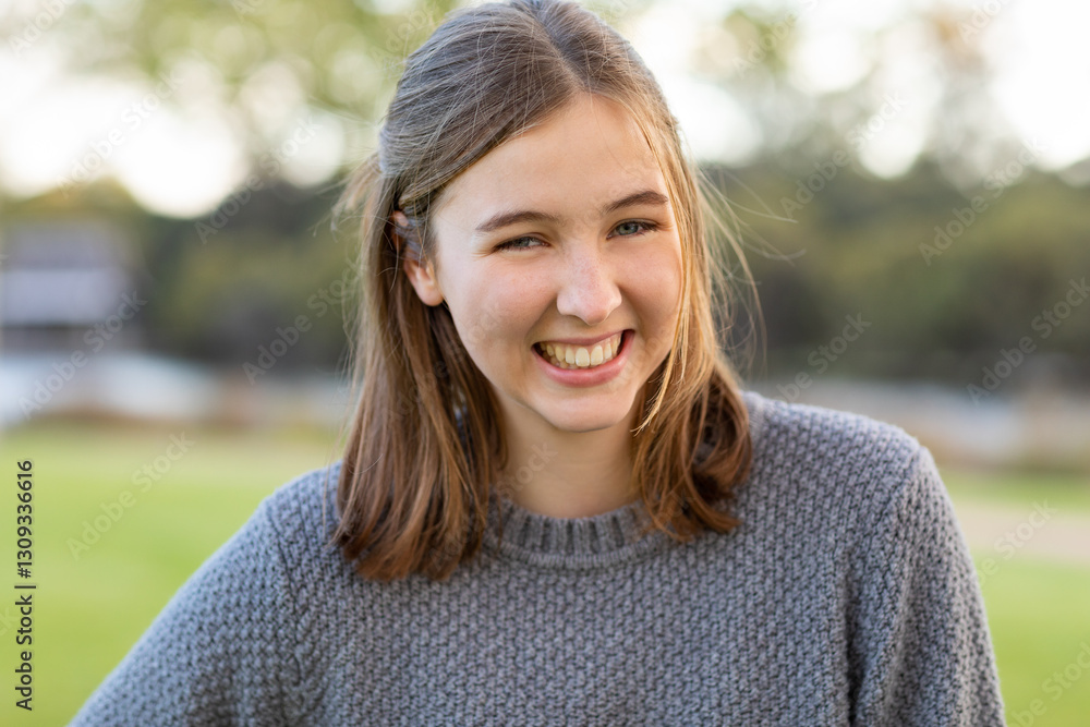happy smiling teenager wearing grey sweater outdoors happy smiling teenager wearing grey sweater outdoors