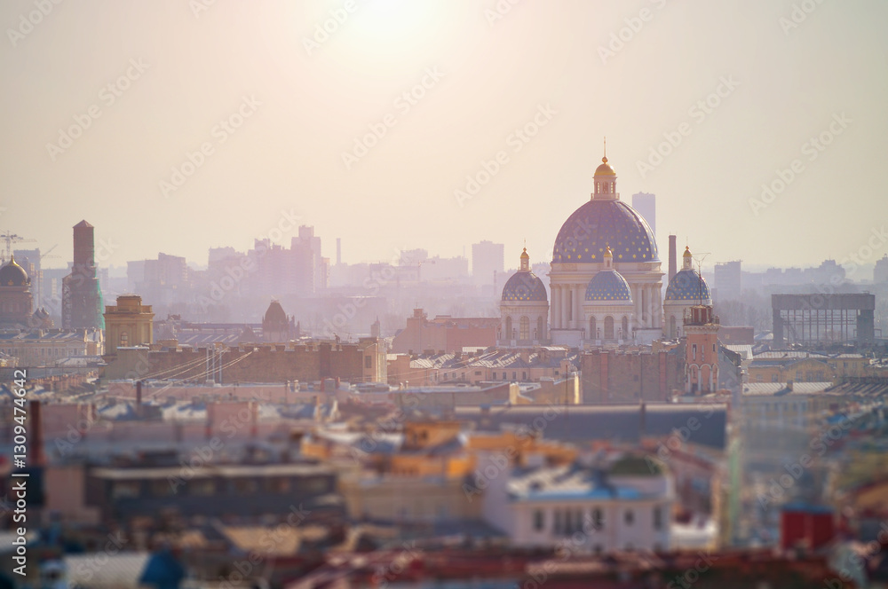 Fototapeta premium St Petersburg, Russia. Sunrise view from height at the building roofs and Holy Trinity Izmailovo Cathedral. Tilt shift effect and soft filter applied