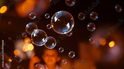 Colorful soap bubbles floating in the air with a blurred child in the background for joyful moment concept