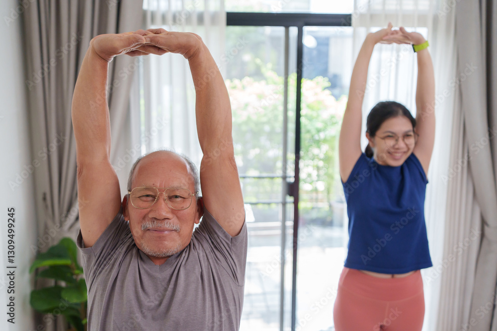 Fototapeta premium Asian senior man and young woman engage in stretching exercises in their living room. Focusing on maintaining flexibility and strength while enjoying quality time together.