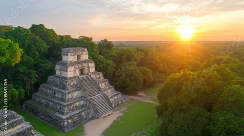 Sunrise over ancient Mayan pyramid nestled in lush jungle, aerial view. photo