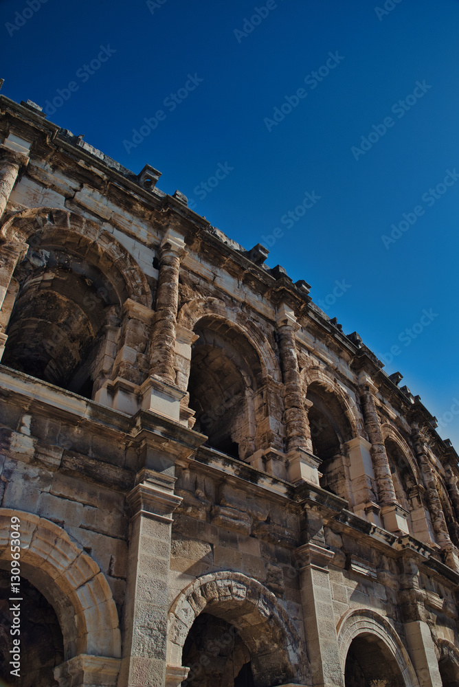 Roman amphitheater located in the French city of Nîmes, in the department of Gard, in the Occitania region Nîmes, in the Occitania region of southern France. Roman amphitheater located in the French city of Nîmes, in the department of Gard, in the Occitania region Nîmes, in the Occitania region of southern France.