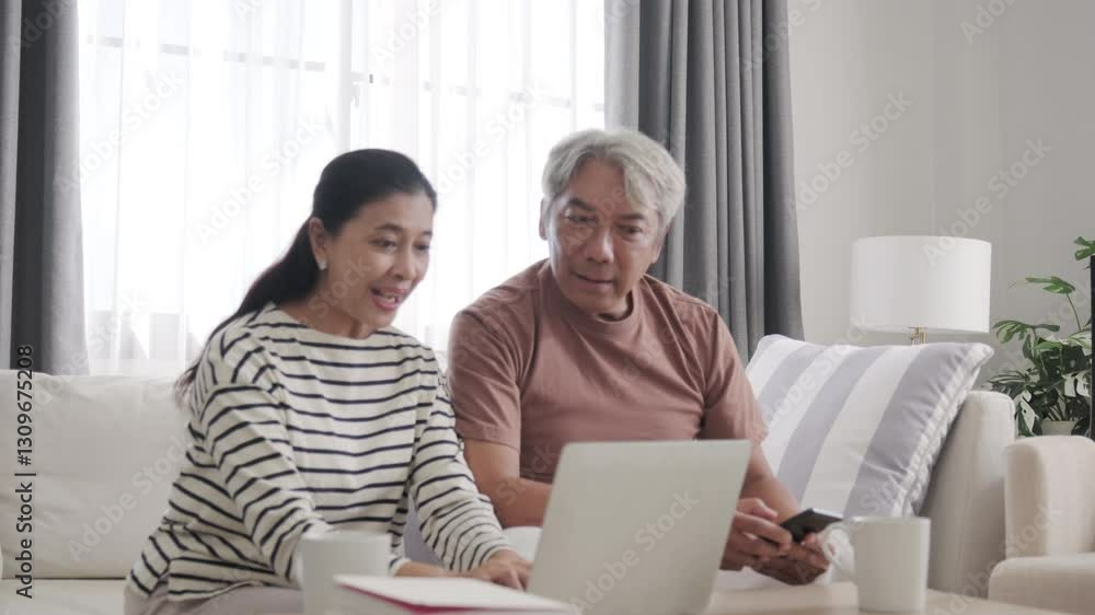 Senior Asian couple looking laptop and happy. Senior Asian couple looking laptop and happy.