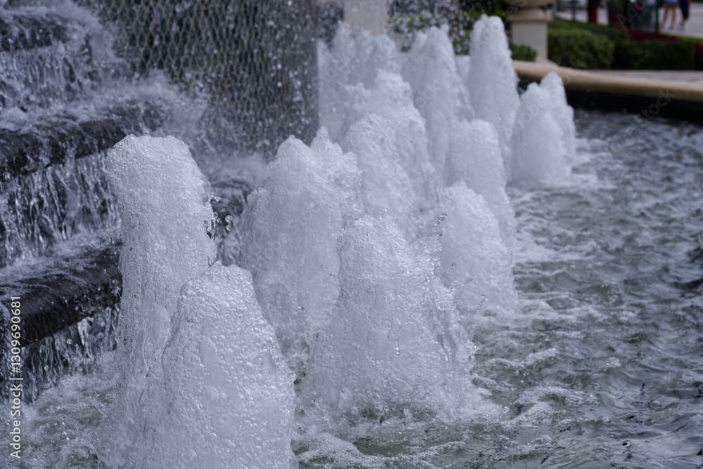 Cascade fountain with water flowing over steps. Urban city landscape design. Abstract background. Cascade fountain with water flowing over steps. Urban city landscape design. Abstract background.