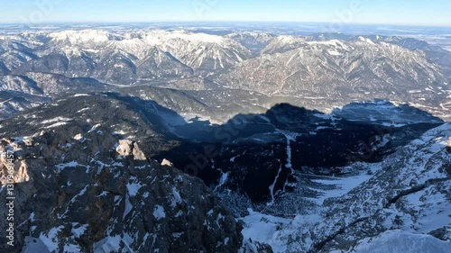 View from Zugspitze of snow covered mountains and Eibsee lake