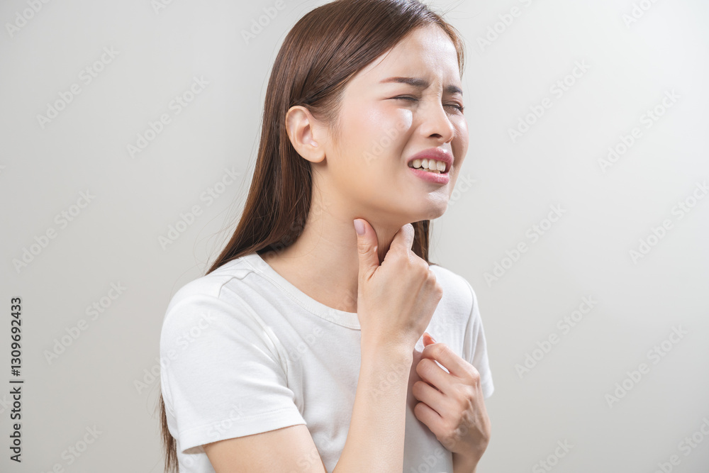 Sickness in inflaming asian young woman, girl use hand check self touch at sore throat, pain thyroid gland on neck or disease reflux, acid of suffer people on wall background. Medical and healthcare. Sickness in inflaming asian young woman, girl use hand check self touch at sore throat, pain thyroid gland on neck or disease reflux, acid of suffer people on wall background. Medical and healthcare.