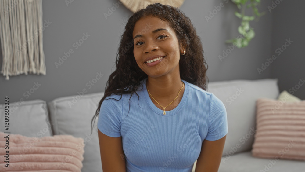 Φωτογραφία Young latin woman smiling indoors in apartment living room with comfortable deco