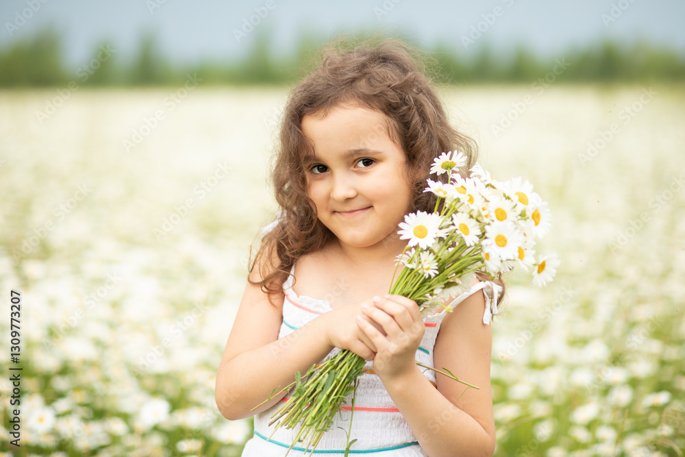 Cute little child girl at chamomile field picking flowers Cute little child girl at chamomile field picking flowers