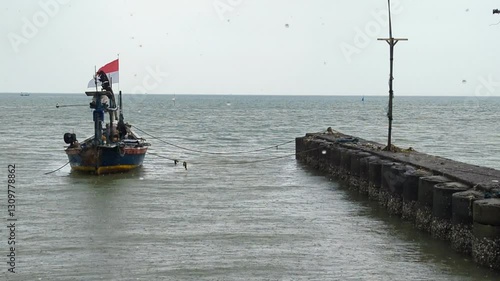 Fishermen boats leaning in the middle of the sea using an anchor tied to both sides of the boat against an empty space background for advertising.