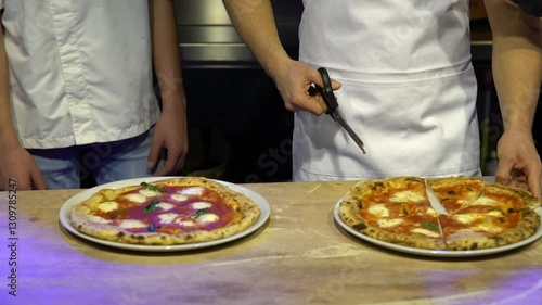 Close-up timelapse of two freshly baked pizzas: crispy crust, melted cheese, vibrant toppings. Chef slices them with scissors, showcasing unique technique. Ideal for ads, cooking videos, restaurants. 