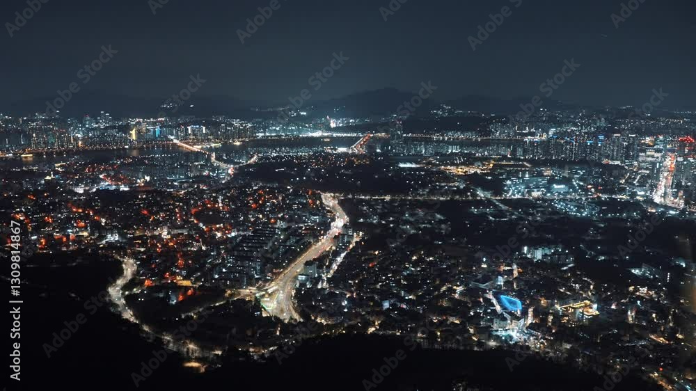 Stunning aerial night view of Seoul, South Korea, captured from N Seoul Tower, showcasing the illuminated cityscape, modern skyscrapers, and vibrant urban life