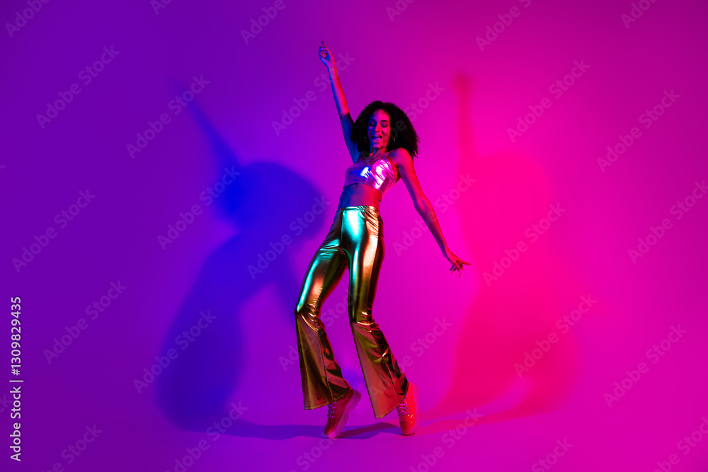 Young woman dancing in vibrant neon lighting, wearing glamorous retro fashion with metallic gold pants, expressing joy and positivity Young woman dancing in vibrant neon lighting, wearing glamorous retro fashion with metallic gold pants, expressing joy and positivity