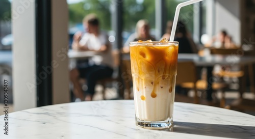  Iced Caramel latte on marble table in cafe for coffee shop menu. Refreshing summer drink for International Coffee Day, birthday, advertising coffee house. photo