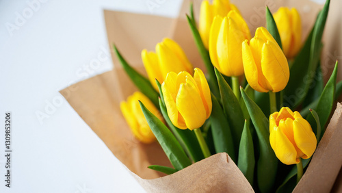 Vibrant Yellow Tulips Bouquet Wrapped in Rustic Craft Paper for Eco-Friendly Spring Promotions & Easter Campaigns photo