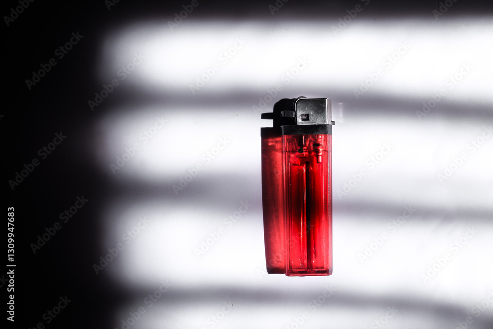 A Lighter in Dramatic Lighting with Shadow Patterns A Lighter in Dramatic Lighting with Shadow Patterns