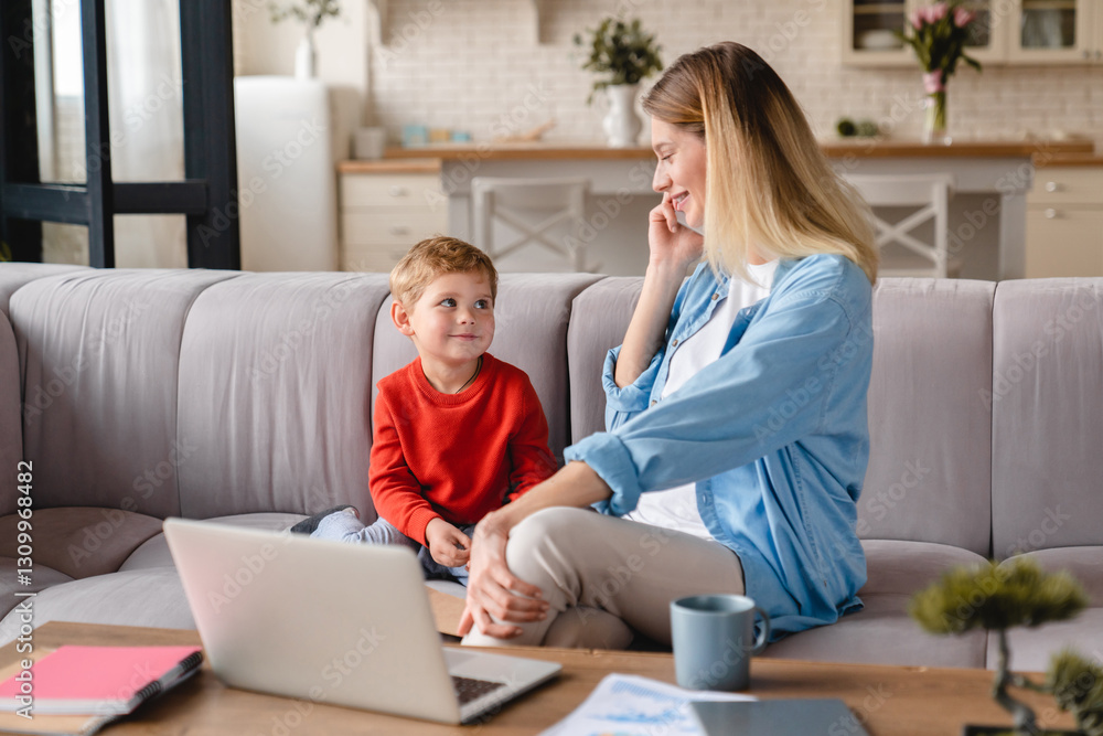 Young caucasian pregnant multitasking mother working at home on freelance at the desk taking care of her baby son at the remote distant office. Maternity leave concept Young caucasian pregnant multitasking mother working at home on freelance at the desk taking care of her baby son at the remote distant office. Maternity leave concept