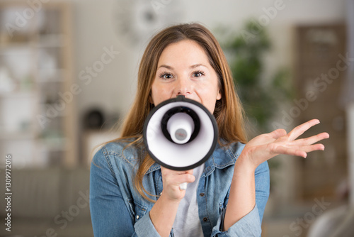 woman talking through a megaphone and gesticulating