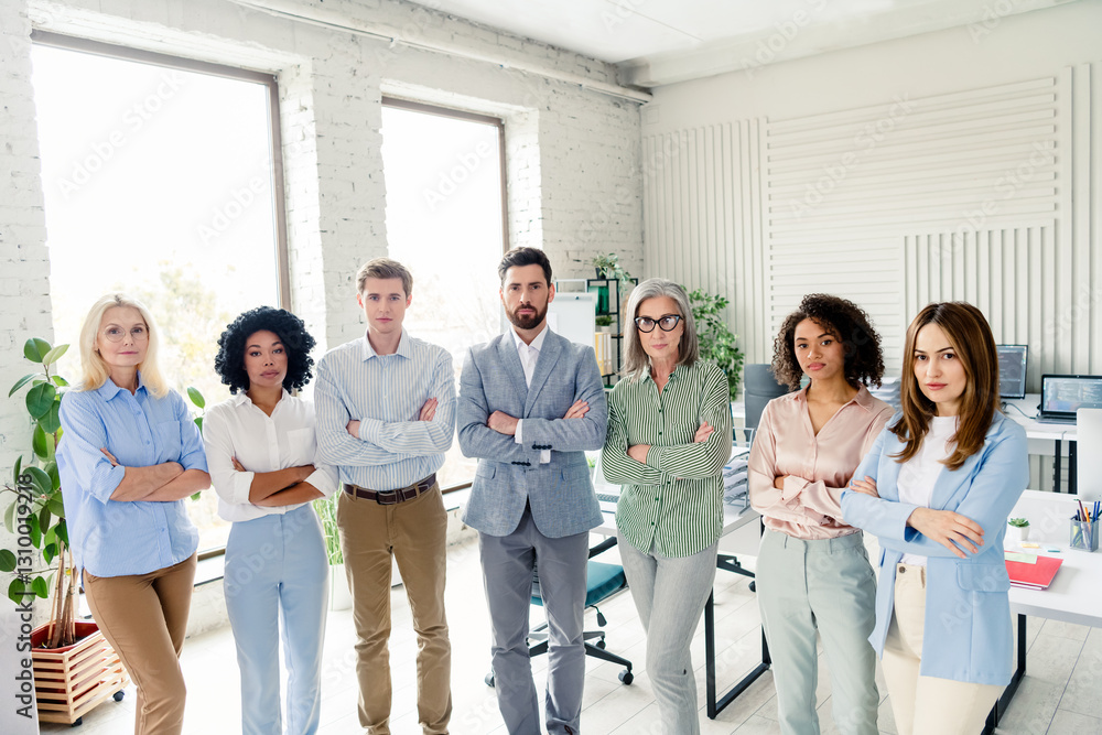Group of diverse professionals standing confidently in an office workspace, conveying teamwork, productivity, and collaboration Group of diverse professionals standing confidently in an office workspace, conveying teamwork, productivity, and collaboration