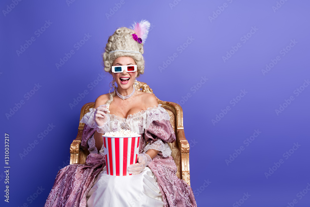 Woman in elegant historical attire enjoying popcorn with 3D glasses on purple background Woman in elegant historical attire enjoying popcorn with 3D glasses on purple background