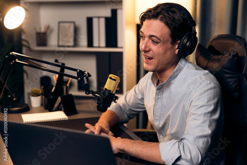 Canvas Print Host channel smart broadcaster talking on live social media application searching on laptop, broadcasting streamer wearing headphone using mic at modern home office studio in warm lighting