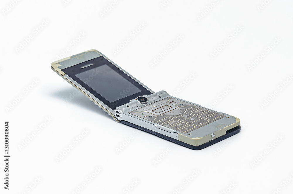 Retro silver flip phone with scratched screen on white backdrop Retro silver flip phone with scratched screen on white backdrop