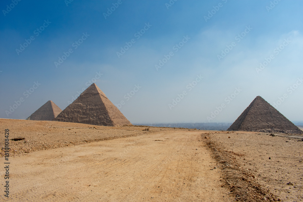 View of The Giza Necropolis, Famed archaeological site featuring the Great Pyramids, the Great Sphinx and The Great Pyramid of Giza in the desert of Giza, Cairo, Egypt. View of The Giza Necropolis, Famed archaeological site featuring the Great Pyramids, the Great Sphinx and The Great Pyramid of Giza in the desert of Giza, Cairo, Egypt.