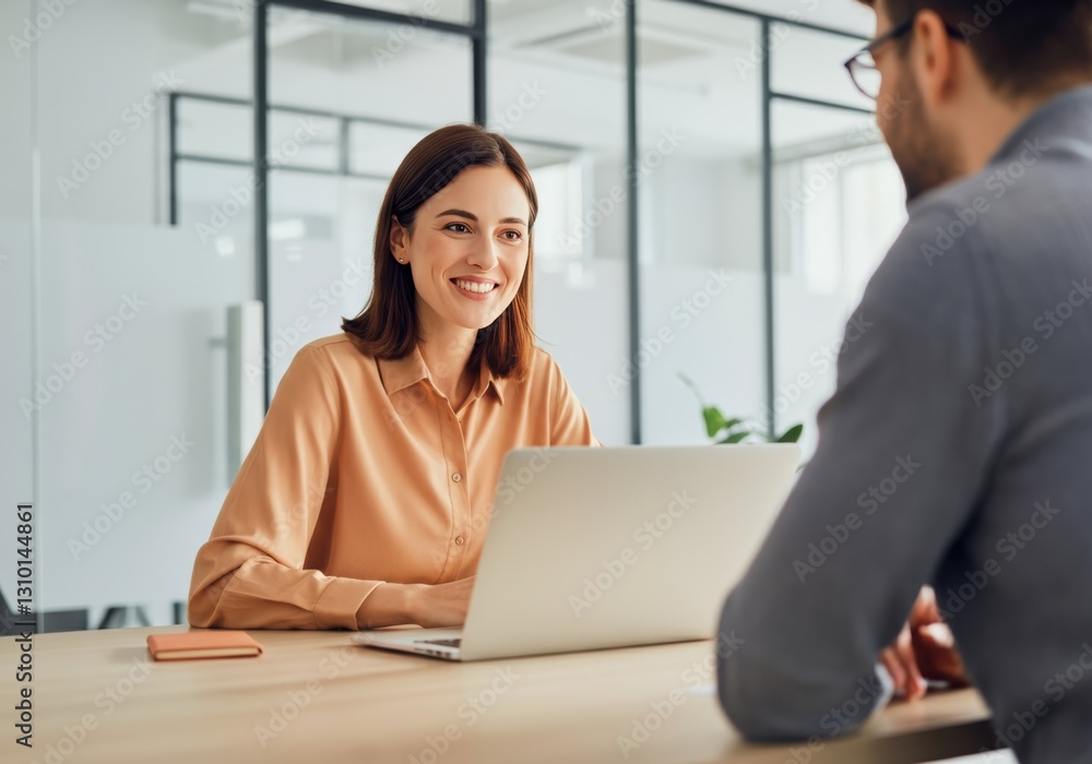 Smiling woman working on a laptop during a business meeting Smiling woman working on a laptop during a business meeting