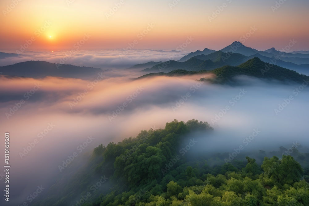 Fototapeta premium mountains covered in fog and low clouds at sunset