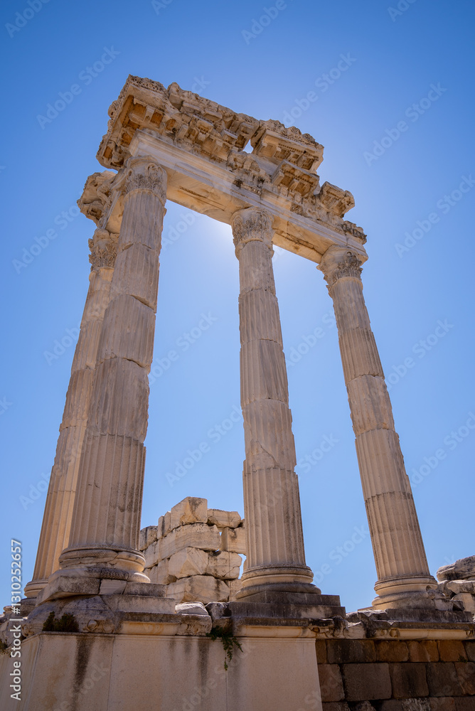 Historical view of greek antique city of Bergama. Ancient architectural landscape with marble columns and walls with a blue background. Ancient city of Pergamon. Archaeology and tourism concept backgr Historical view of greek antique city of Bergama. Ancient architectural landscape with marble columns and walls with a blue background. Ancient city of Pergamon. Archaeology and tourism concept backgr