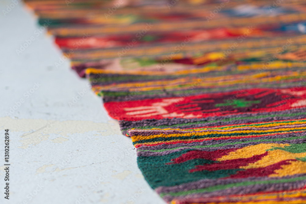Fototapeta premium Close-up image of a colorful, patterned textile with an intricate design and soft, dense weave The textile appears to be part of a larger piece like a rug or tapestry, with no visible texts The pho