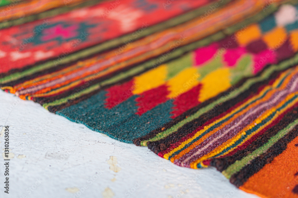 Fototapeta premium Close-up image of a vibrant, handmade textile with floral and geometric patterns