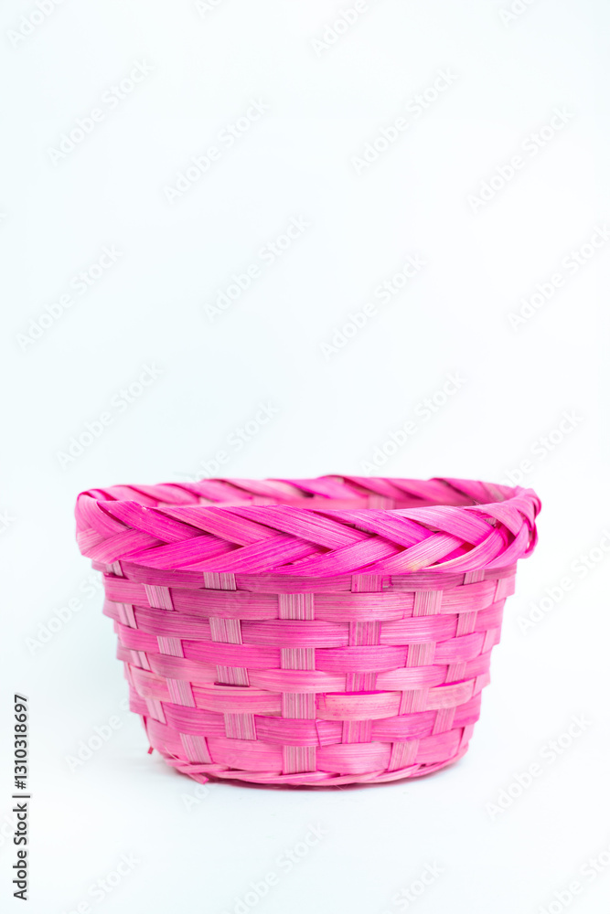 A delicate pink basket with a woven pattern, beautifully isolated on a bright white background. The soft color and natural texture evoke a sense of warmth, nostalgia, and craftsmanship. A delicate pink basket with a woven pattern, beautifully isolated on a bright white background. The soft color and natural texture evoke a sense of warmth, nostalgia, and craftsmanship.