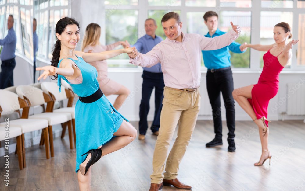 Fototapeta premium Adult man and young woman dancing in dance class