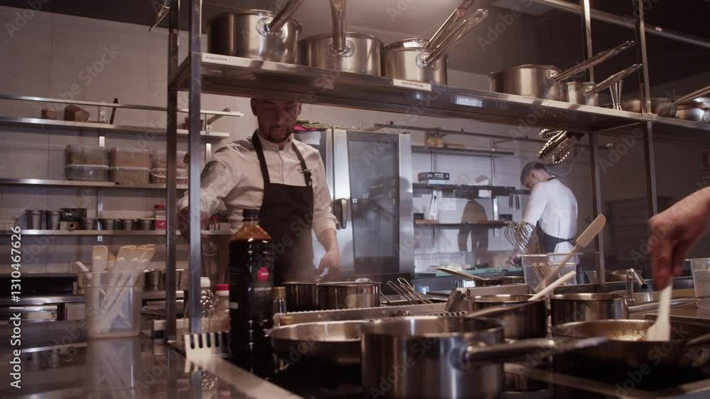 Unrecognizable man frying ingredients in pan with spoon in kitchen Unrecognizable man frying ingredients in pan with spoon in kitchen