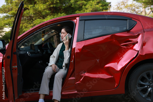 Φωτογραφία A female motorist is standing on the side of the road after a car accident, assessing the damage to her vehicle