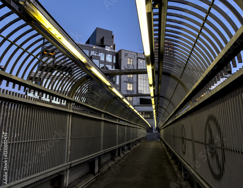fenced bridge overpass fence with tube fluorescent light tunnel (manhattan new york city highway road crossing) motorway pedestrian connector at night dusk sunset