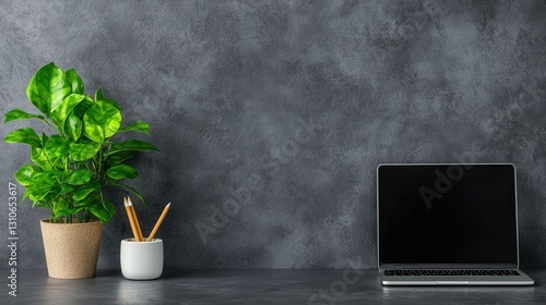 A minimalist desktop setup with greenery, symbolizing eco-friendly workspaces