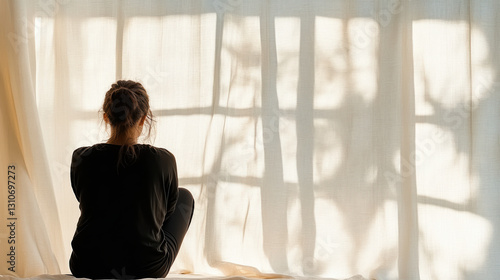 woman sits quietly by window, her silhouette framed by soft curtains Free Download woman sits quietly by window, her silhouette framed by soft curtains - GFXLoad