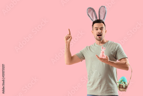 Young man in bunny ears wit...
