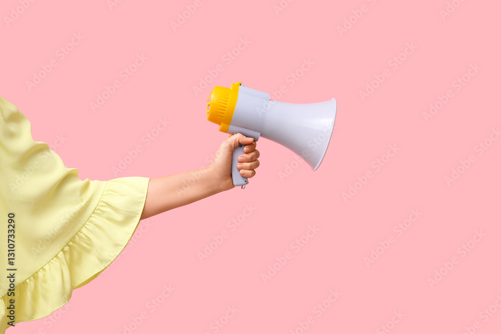 Female hand with megaphone on pink background Female hand with megaphone on pink background