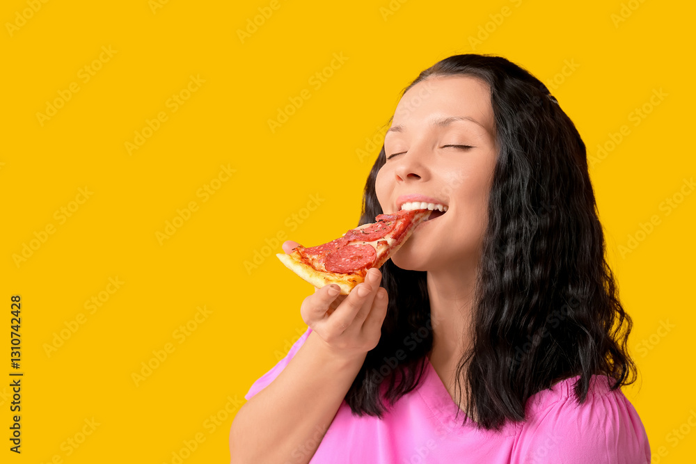 Young woman eating tasty pizza on yellow background, closeup Young woman eating tasty pizza on yellow background, closeup