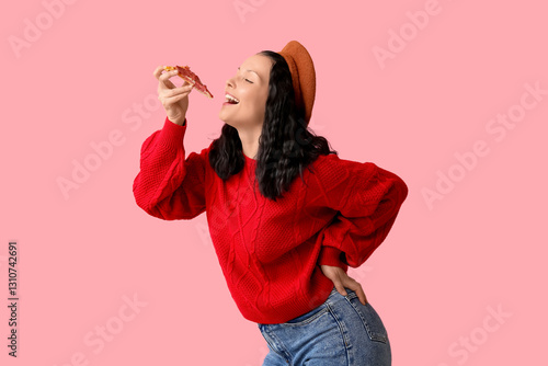 Happy young woman eating ta...